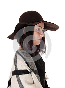 Lovely woman in profile with a hat and poncho