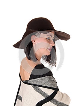 Lovely woman in profile with a hat and poncho