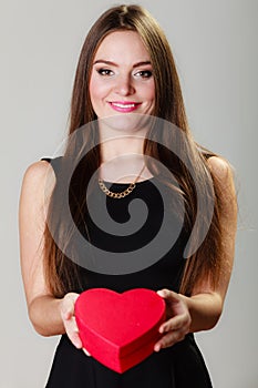 Lovely woman with red heart shaped gift box