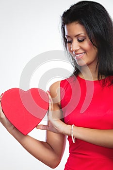 Lovely woman with red heart shaped gift box