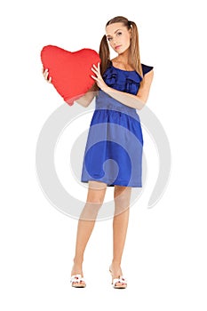Lovely woman with red heart-shaped pillow