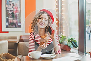 Lovely woman with smartphone in cafe