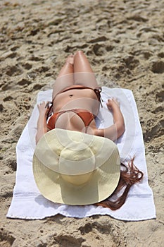 Lovely woman sunbathing outdoors at the beach