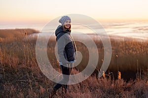 Lovely woman watching sunset in the nature