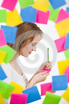 Lovely woman writing surrounded by photo