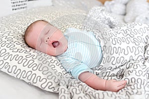 Lovely yawning 1 months baby girl in the parents bed