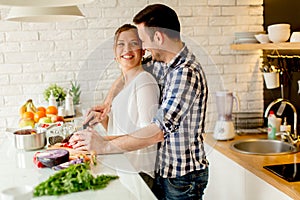 Young couple preparing healthy meal in the kitchen