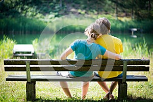 Lovely young couple sitting on bench