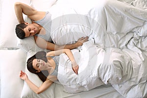 Lovely young couple sleeping in large bed,  view