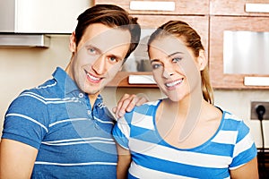 Lovely young couple standing in kitchen