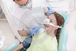 Lovely young girl at dental checkup at the clinic