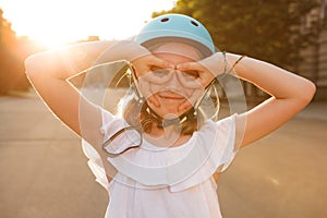 Lovely young girl enjoying rollerblading outdoors