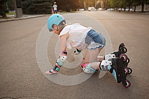 Lovely young girl enjoying rollerblading outdoors