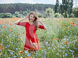 Lovely young romantic woman in straw hat on poppy flower field posing on background summer. Wearing straw hat. Soft