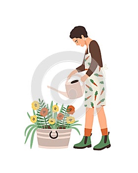 Lovely young smiling woman or gardener taking care of home garden, watering houseplants growing in planters. Portrait of