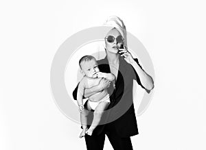 Lovely young working mother and her baby. Work life balance concept. Working mother working at home. Business woman