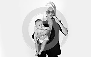 Lovely young working mother and her baby. Work life balance concept. Working mother working at home. Business woman