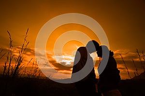 Lover couple in sunset background