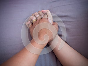 Lover hands on bed