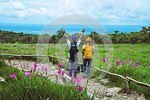 Lover woman and men Asian travel nature. Travel relax. Photography Cucumber sessilis flower field