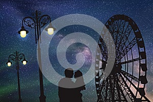 Lovers in amusement park at night