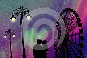 Lovers in amusement park at night