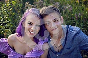 lovers are a beautiful guy with a girl with purple hair and a bouquet of flowers