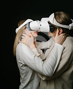 Lovers couple hugging and kissing in VR headset glasses.