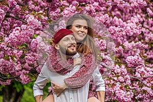 Lovers couple hugging in a sakura. Love, youth, happiness concept. Couple in love outdoor. Sensual outdoor portrait of