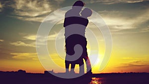 Lovers on a date in sunset, hugging and kissing. Romantic love scene,