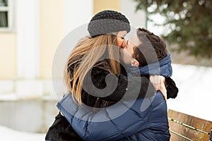 Lovers kissing on the bench