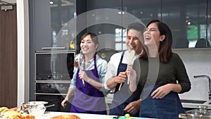 Lovers in kitchen, Friend cooking in the modern kitchen. Asian man and woman cooking together in home kitchen. Young people singin