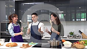 Lovers in kitchen, Friend and couple are cooking in the modern kitchen. Asian man and woman cooking together in home kitchen. Youn