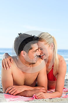 Lovers lying down on the beach