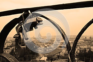 Lovers padlocks on a bridge. View from the Pincian hill in Rome, Italy