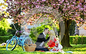 Lovers sensual kissing. Couple in love picnic date. Spring weekend. My treasure. Romantic proposal. Enjoying their