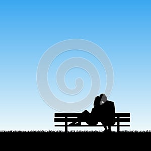 Lovers sitting on bench in park