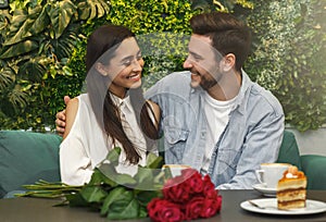 Lovers Sitting And Embracing On Romantic Date In Cozy Cafetera photo