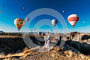 Lovers travel to Turkey. The man proposed to the girl. Family trip to Turkey. Couple at the balloon festival. Honeymoon trip.