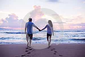 Lovers Walking on the Beach at Sunset on Vacation