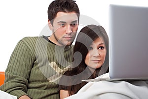 Lovers watching a movie on their laptop