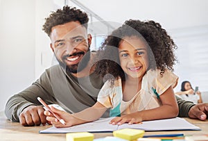 She loves drawing with dad. a young father helping his daughter with homework at home.