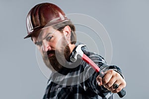 He loves his job. brutal technician builder. factory worker mechanic. industrial worker in helmet. man with hammer tool