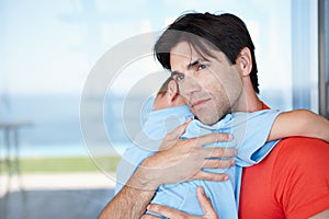 He loves his son so much. a loving father tenderly embracing his young son.