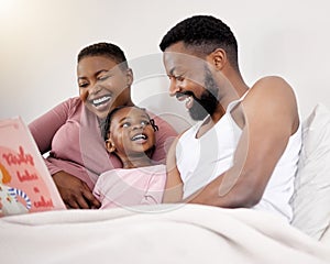 She loves story time. a young family bonding in bed together.