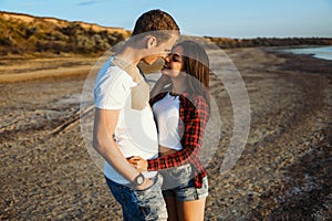 Lovestory of couple on the beach On the Sunset