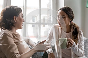 Loving 50s old woman sharing life news with grown daughter.