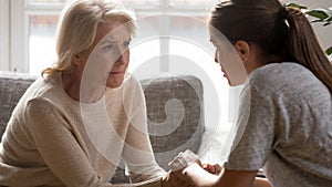 Caring grownup daughter comfort unhappy older mother