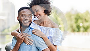 Loving african-american couple in love hugging in park