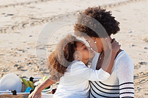 Loving African American family on picnic on beach